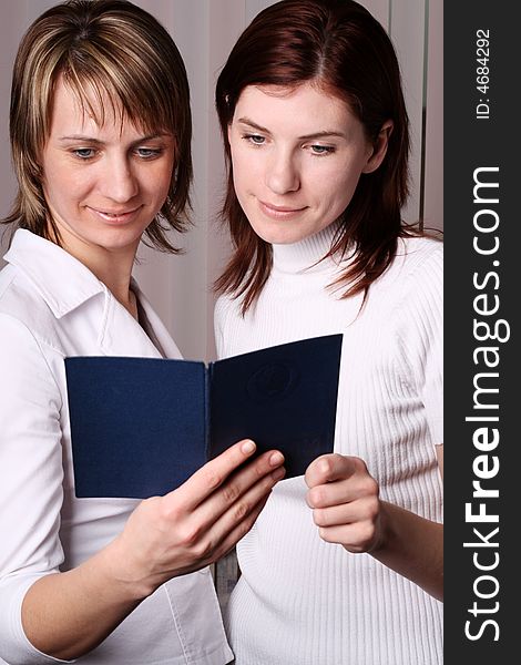 Two girls at office cost and consider documents