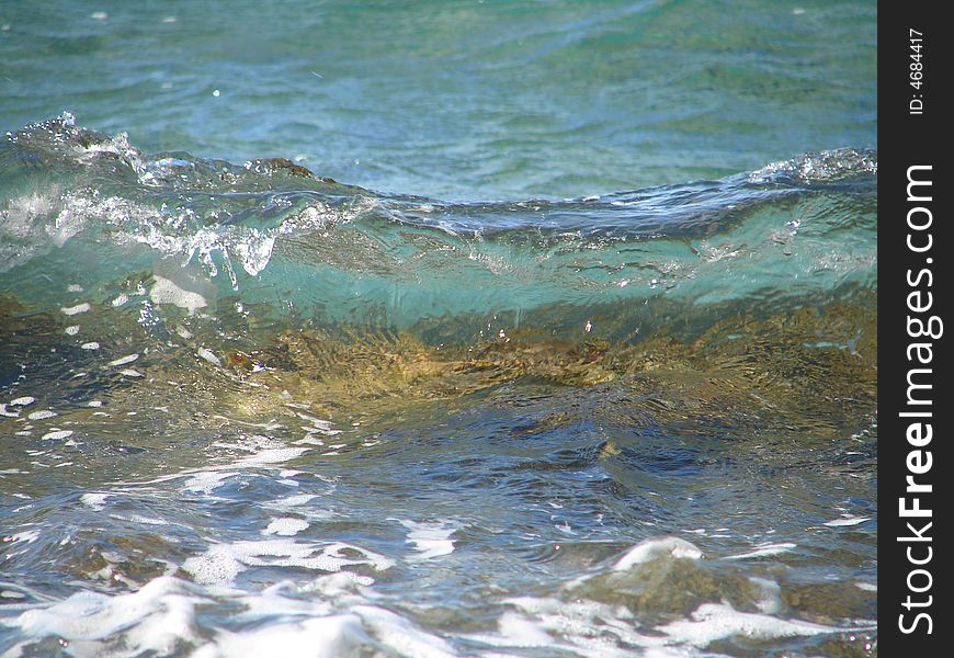 Small wave on crystal clear water