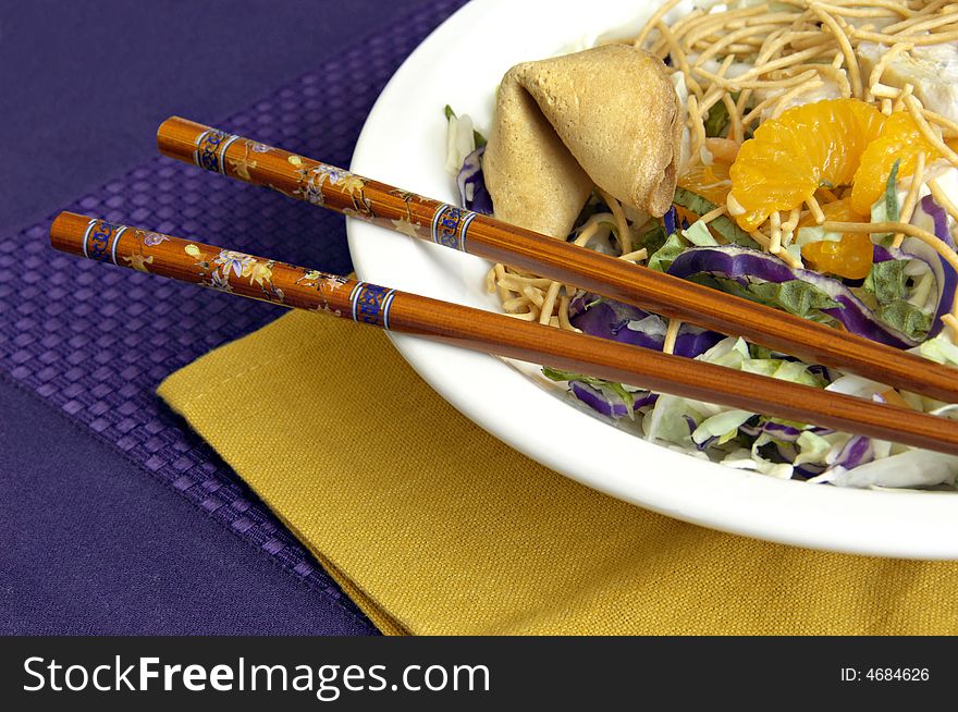 Asian chicken salad with chopsticks and a fortune cookie. Asian chicken salad with chopsticks and a fortune cookie.