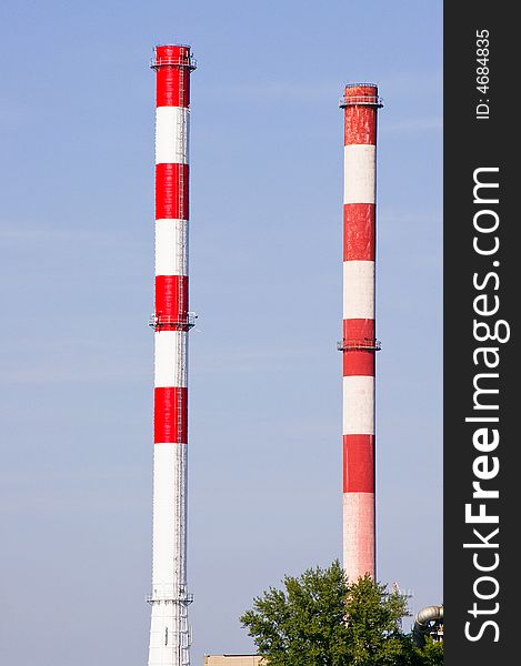 Tall two colored industrial chimneys