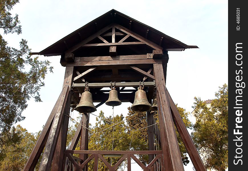 Little Wooden Belfry with three Bells Hanging