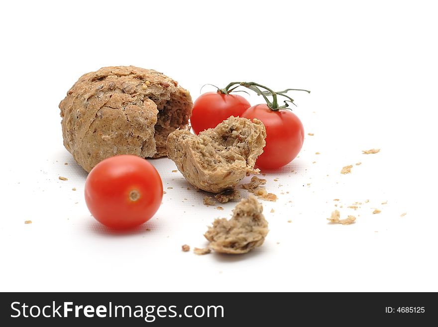 Red tomato and a lot of crumbs of bread. Red tomato and a lot of crumbs of bread