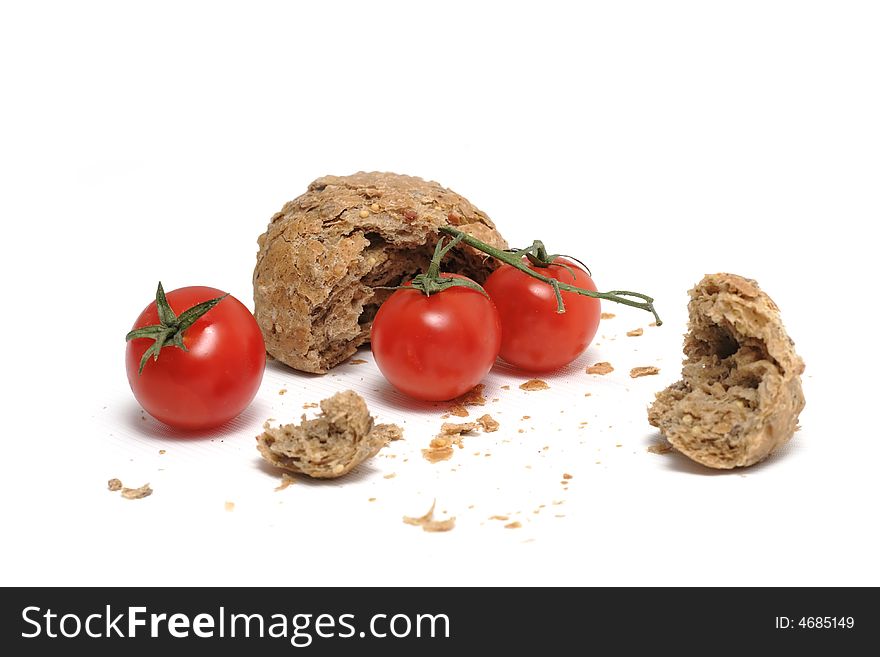 Red tomato and a lot of crumbs of bread. Red tomato and a lot of crumbs of bread