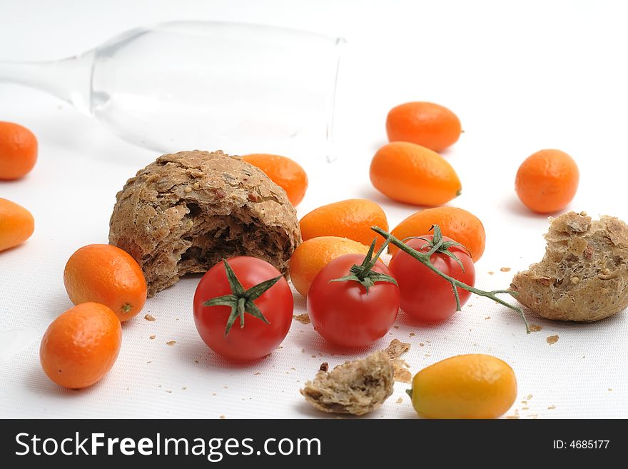 Red tomato and a lot of crumbs of bread. Red tomato and a lot of crumbs of bread