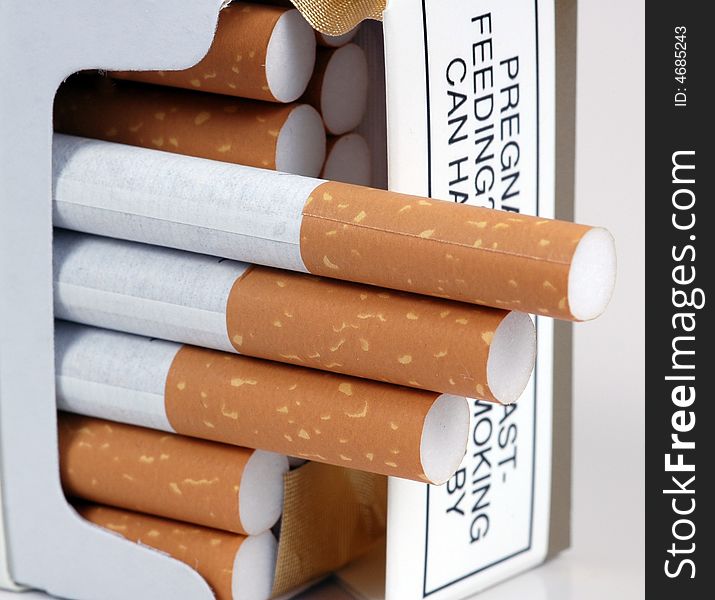 Cigarettes being offered from a packet.  A macro image. Cigarettes being offered from a packet.  A macro image.