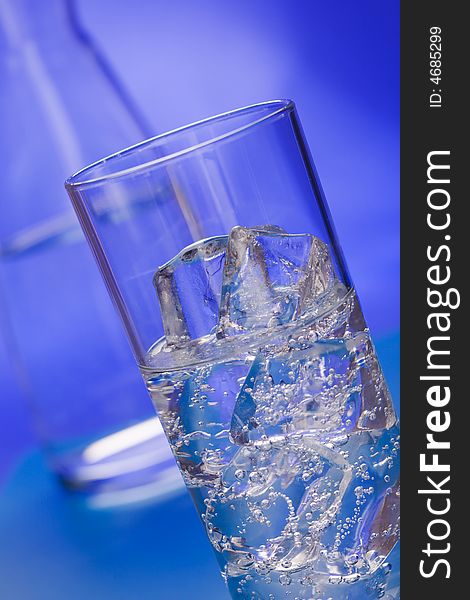 Glass of sparkling water glass with ice cubes