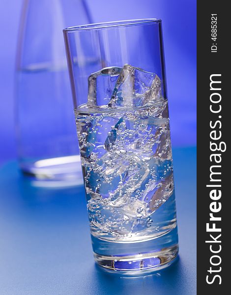 Glass of sparkling water glass with ice cubes