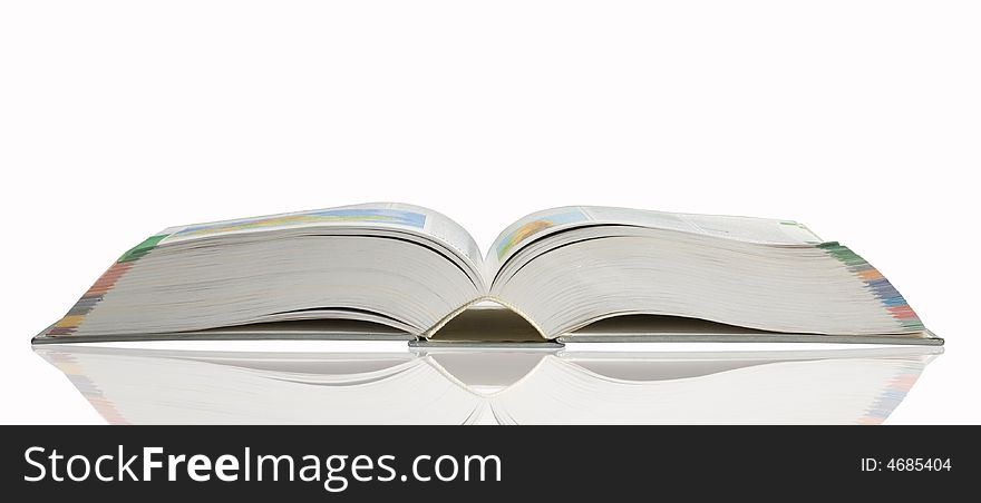 Opened book with reflection on white background