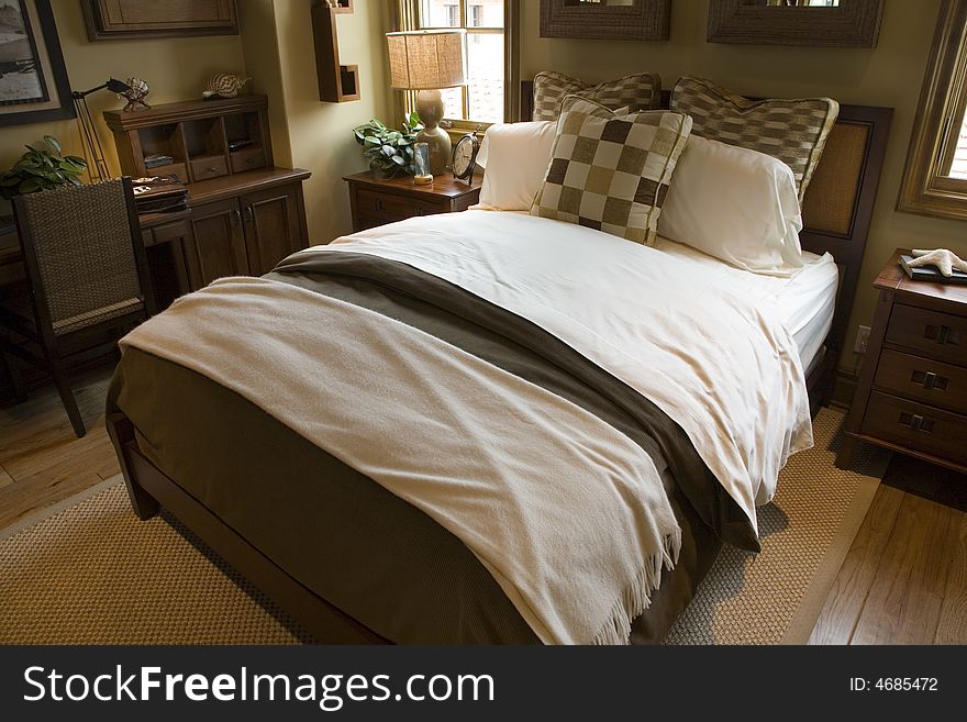 Comfortable bedroom in a luxury home with stylish decor. Comfortable bedroom in a luxury home with stylish decor.