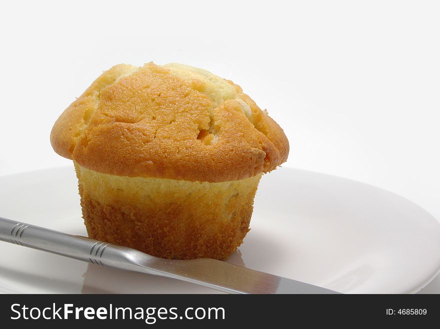 White chocolate jam filled muffin on a white plate. White chocolate jam filled muffin on a white plate