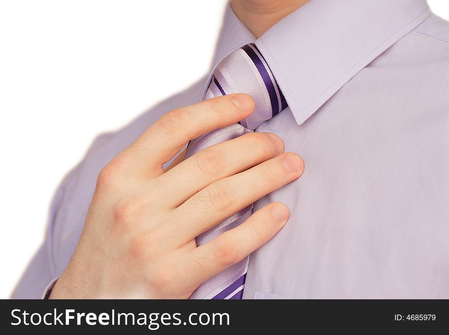 Businessman tying a necktie with hand over white