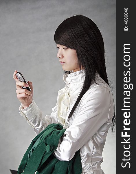 China's white-collar class image...She is looking over the information in the mobile phone. China's white-collar class image...She is looking over the information in the mobile phone.