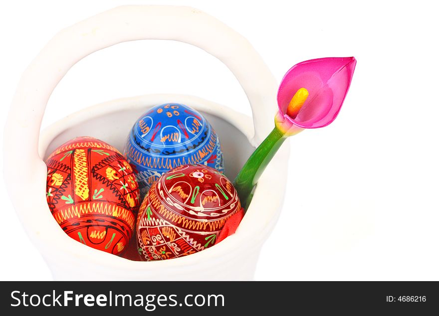 Three russian tradition easter eggs and violet orchid in white porcelain basket. Three russian tradition easter eggs and violet orchid in white porcelain basket