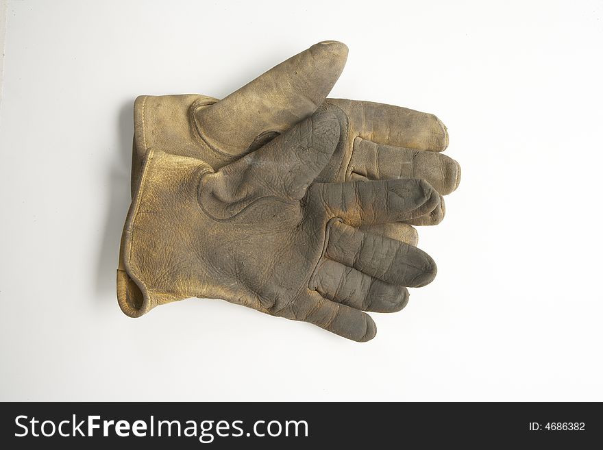 Image of a pair of right gloves without the left glove.  These are calf skin work gloves used for gardening and other outside labor.  It is viewed from overhead. Image of a pair of right gloves without the left glove.  These are calf skin work gloves used for gardening and other outside labor.  It is viewed from overhead.