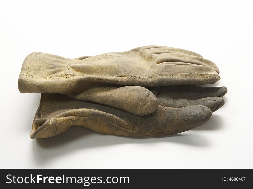 Image of a pair of right gloves without the left glove.  These are calf skin work gloves used for gardening and other outside labor.  Ine glove is on top of the other palm facing each other.  They are viewed from the side. Image of a pair of right gloves without the left glove.  These are calf skin work gloves used for gardening and other outside labor.  Ine glove is on top of the other palm facing each other.  They are viewed from the side.