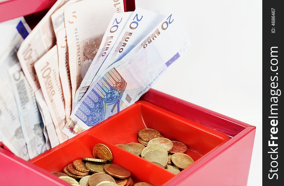 Red cash-box filled with Euro notes and coins