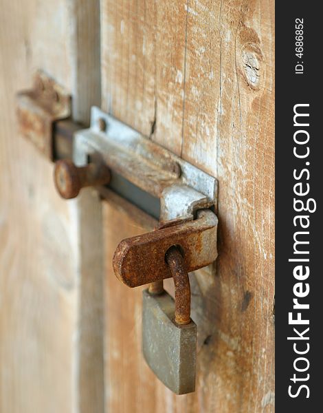 Rusty lock on the wooden door. Rusty lock on the wooden door