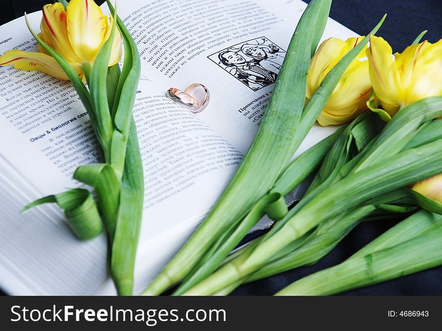 Yellow tulips and book and ring