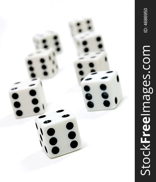 Dice lined up on a white background. Shallow depth of field. Dice lined up on a white background. Shallow depth of field