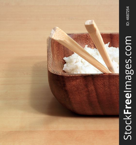 Bowl of rice with wooden chopsticks. Bowl of rice with wooden chopsticks.
