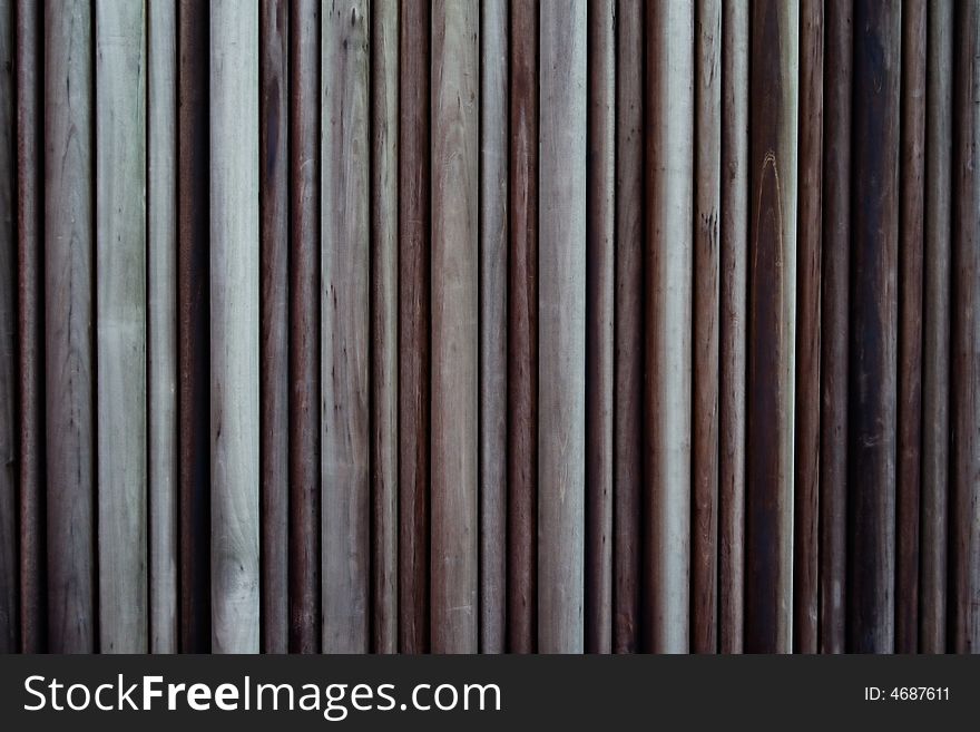 An old wall paneled with logs of wood. An old wall paneled with logs of wood