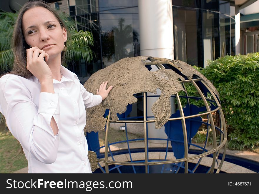 Woman in business attire on her cell phone outdoors. Woman in business attire on her cell phone outdoors