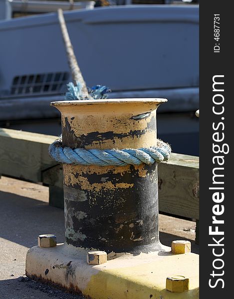 A rope on bit holding ship to dock. A rope on bit holding ship to dock