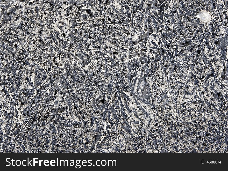 Frozen silt on river bank - natural texture. A shell can be seen. Frozen silt on river bank - natural texture. A shell can be seen