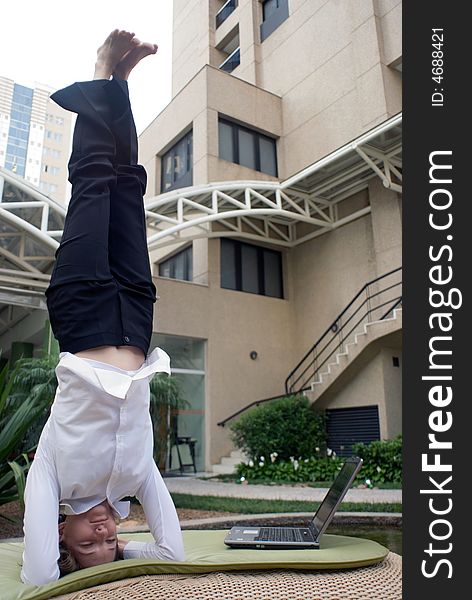 Woman in business attire doing a headstand to clear her head. Woman in business attire doing a headstand to clear her head