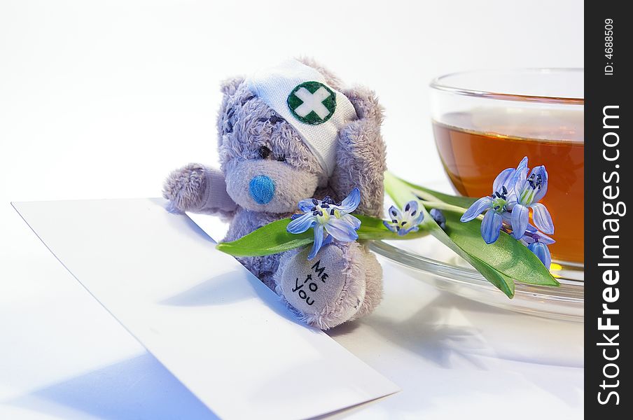 Snowdrops, toy a bear and a cup of tea. Snowdrops, toy a bear and a cup of tea