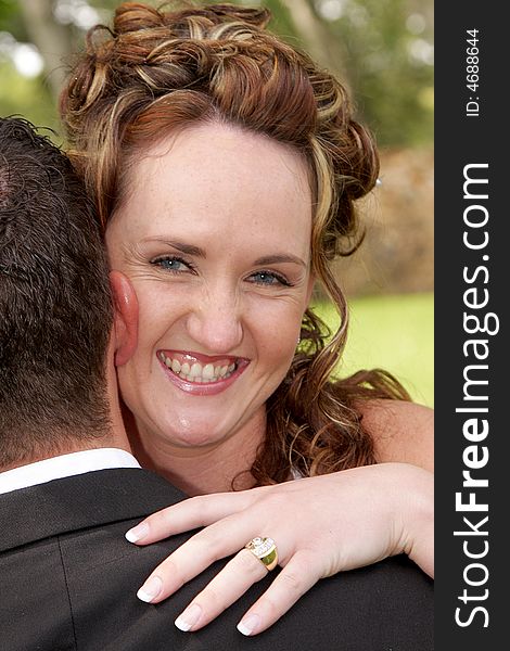 A bride looking over grooms shoulder. A bride looking over grooms shoulder