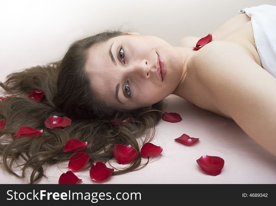 Portrait of young beautiful fashion model with rose leafs