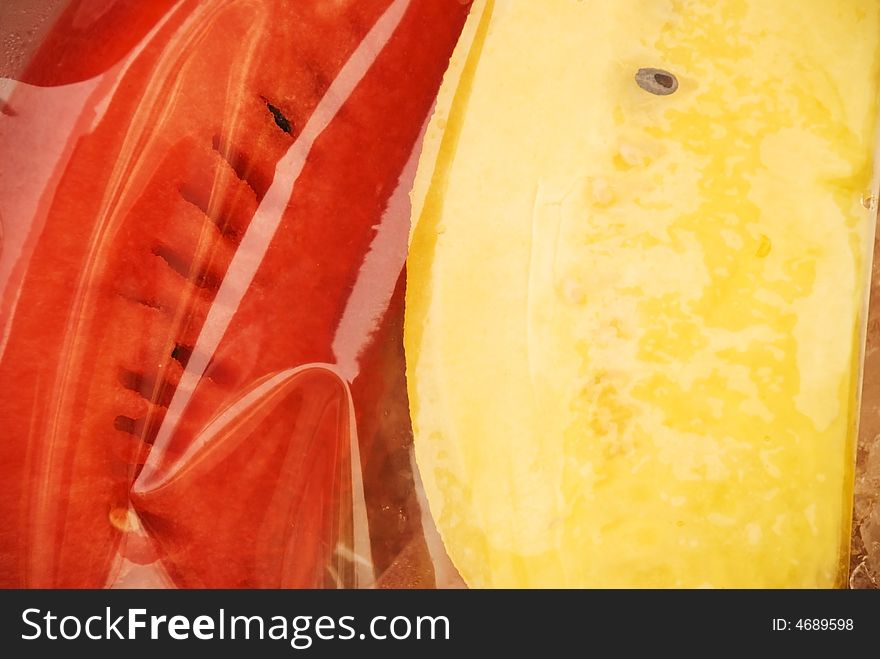 Red and yellow melon in a plastic bag from a market in Thailand. Red and yellow melon in a plastic bag from a market in Thailand