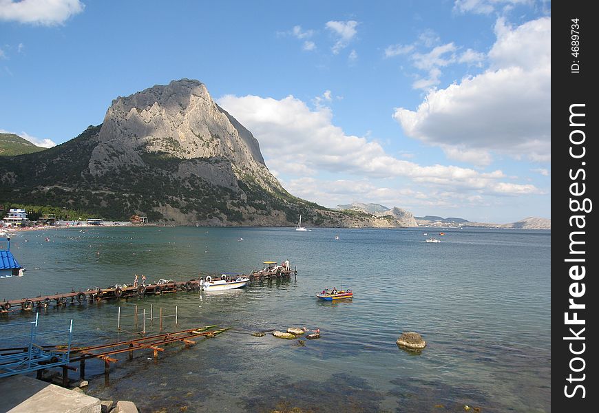 Landscape with sea, rock and boats, recorded in Sudak, Crimea, Black sea.