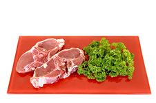 Lamb Chops On Red Plate Stock Images