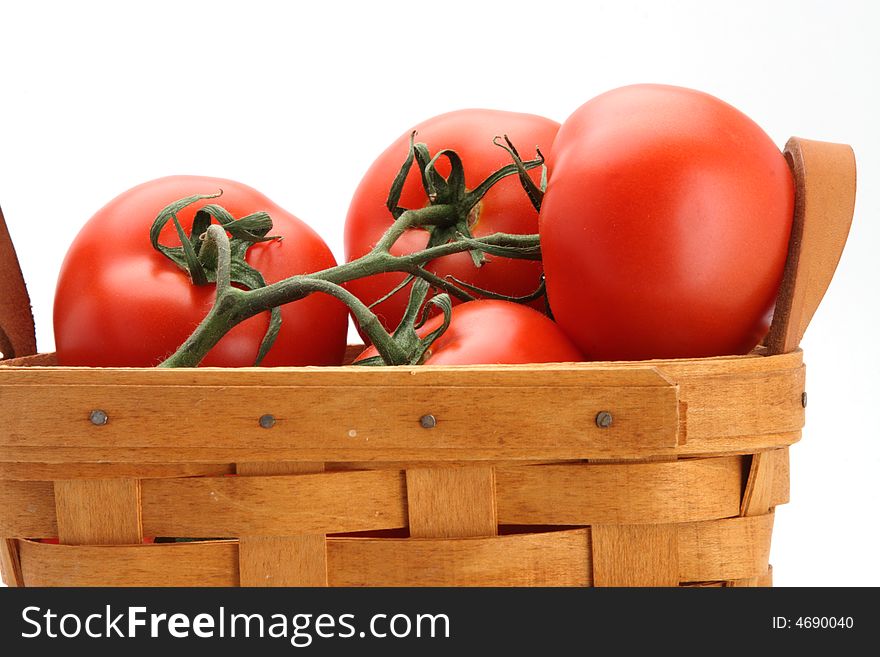 Fresh picked red vine tomatoes in basket white background. Fresh picked red vine tomatoes in basket white background