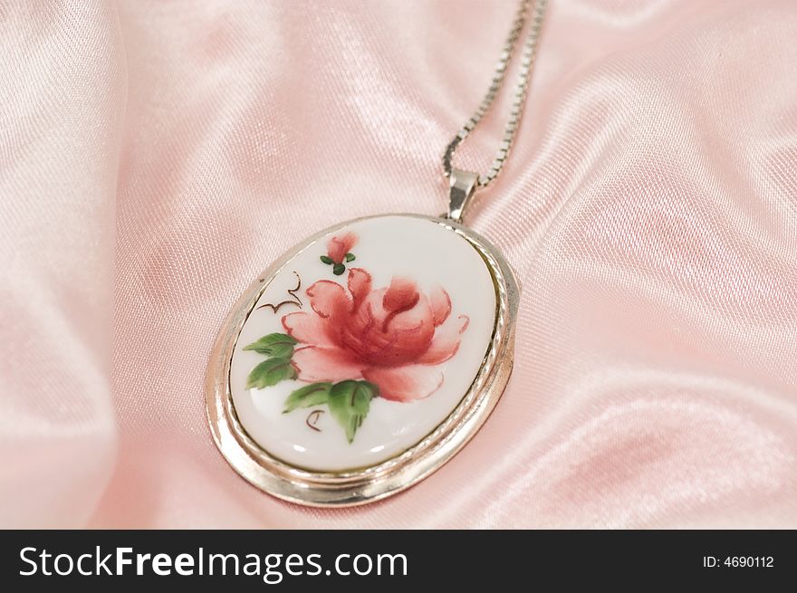 Antique necklace on pink silk