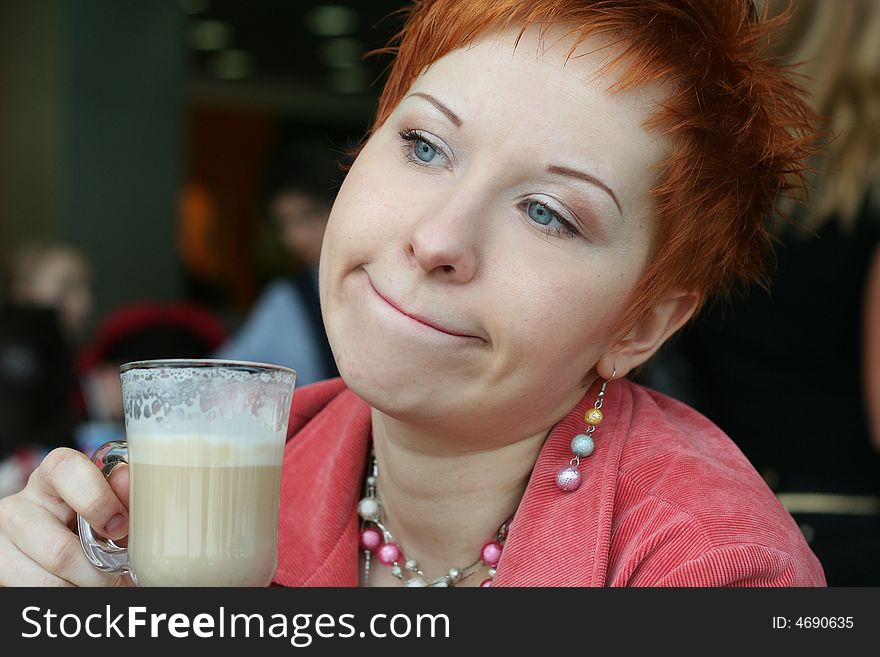 Woman drinking coffee in cafe and looking