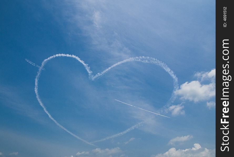 Smoke trial from plane forming a heart. Smoke trial from plane forming a heart