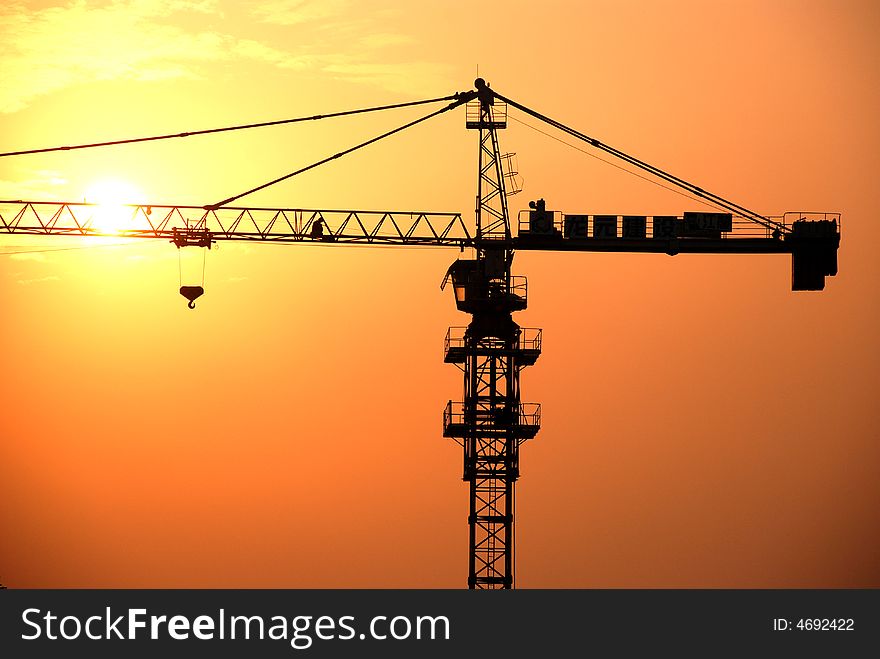 A high steel crane in the beautiful sunset and twilight. A high steel crane in the beautiful sunset and twilight.