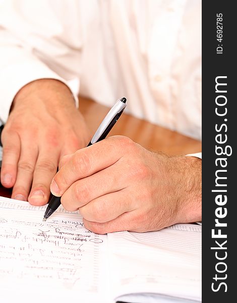 Close-up of businessman writing with pen. Close-up of businessman writing with pen