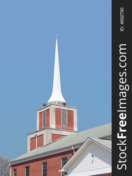 A church steeple against a clear blue sky. A church steeple against a clear blue sky.