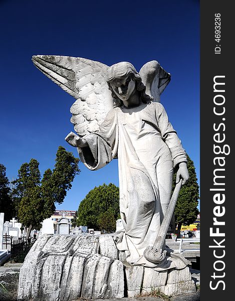 Image of a Stone Angel over a blue sky in cemetery