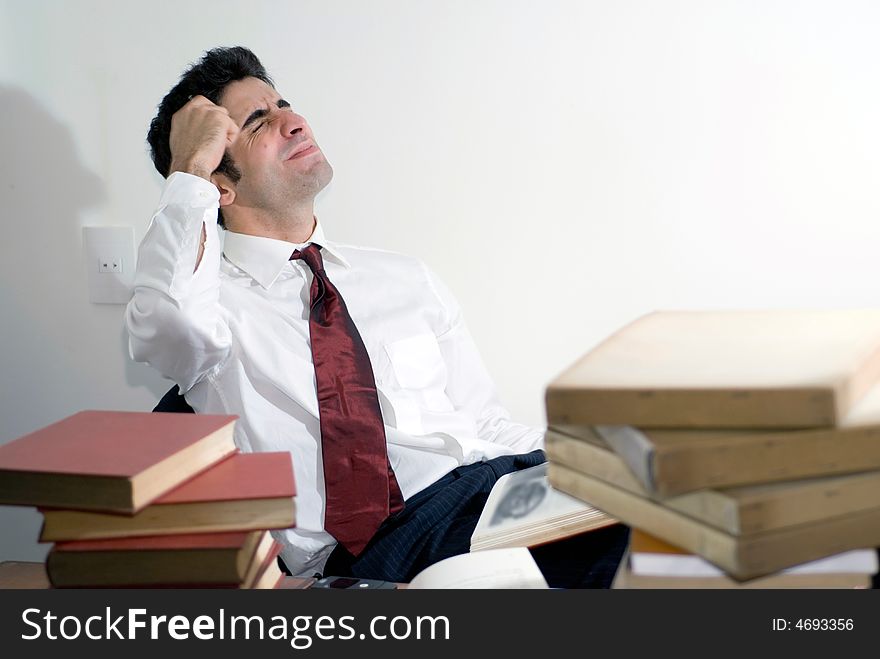 Business man tired after a long day. Isolated against clean white background. Business man tired after a long day. Isolated against clean white background