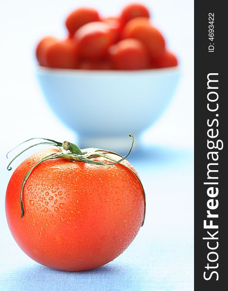 Fresh tomato with water drops on blue. Fresh tomato with water drops on blue