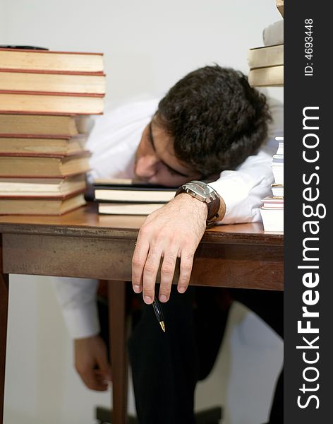 Man in business attire surrounded by books. Man in business attire surrounded by books