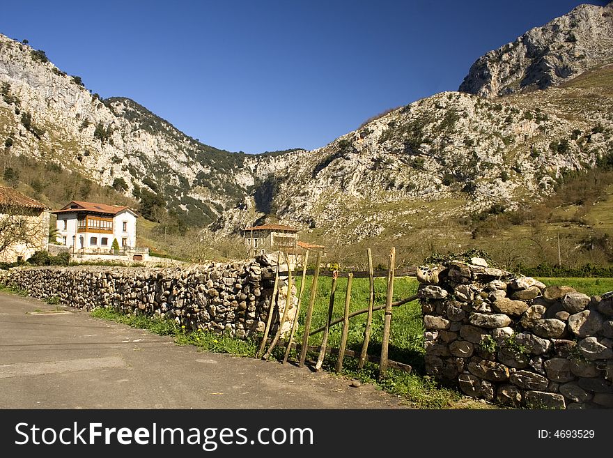 View of a village and mountains from a fence