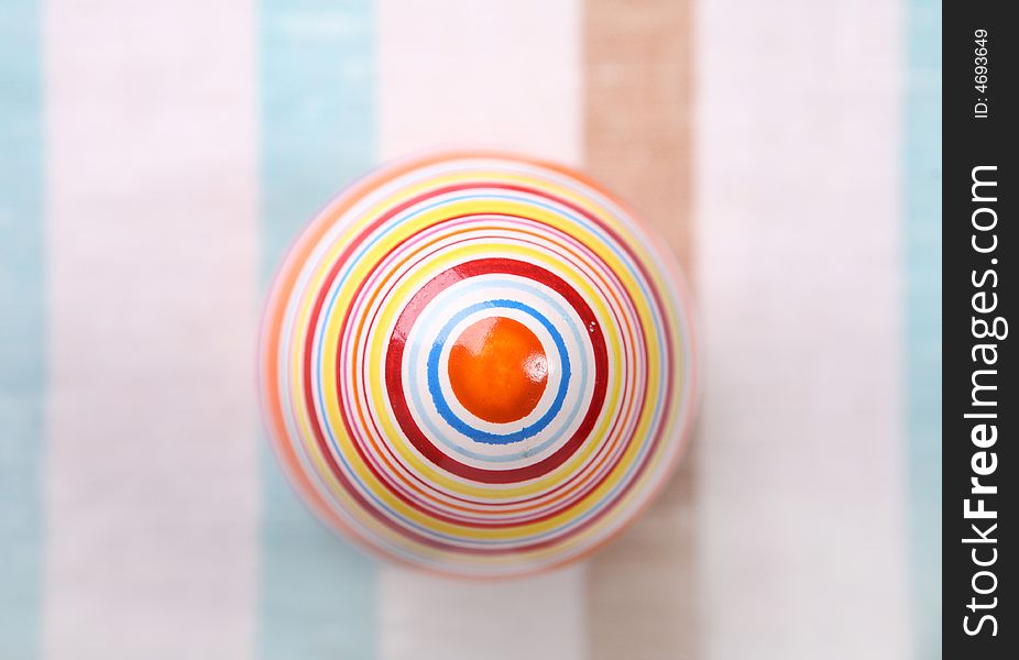 Striped egg on striped cloth - easter decoration