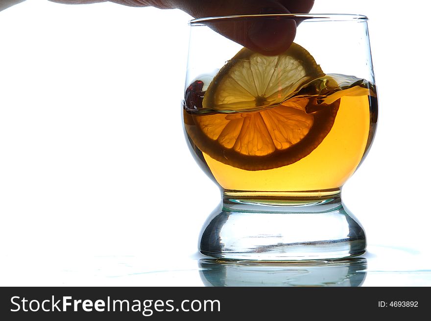 Glass filled with some alcohol, white background, close-up. Glass filled with some alcohol, white background, close-up