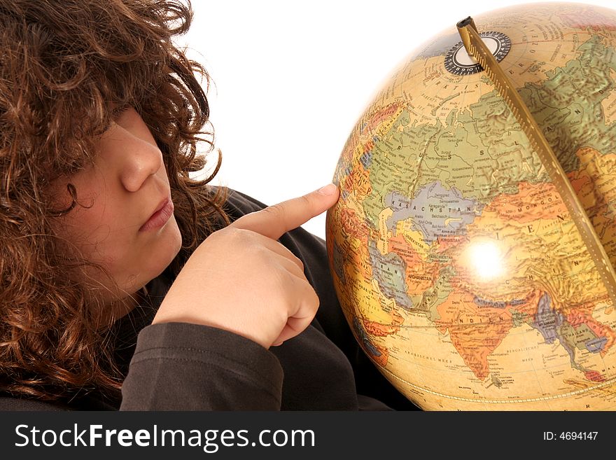 Boy finger pointing on world globe in isolated